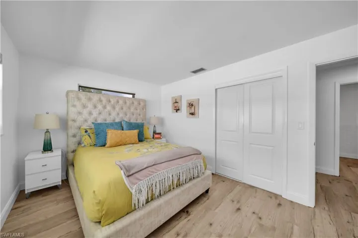 Bedroom with light wood-style flooring and a closet
