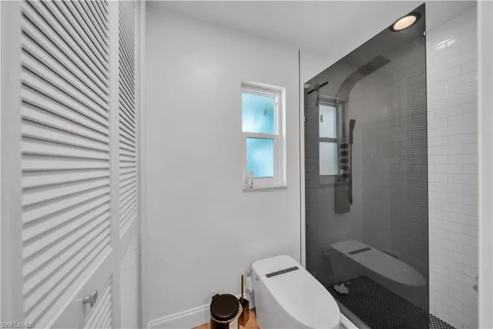 Bathroom with toilet and a tile shower