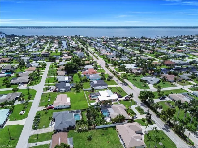 Aerial overview of property's location featuring a large body of water and nearby suburban area