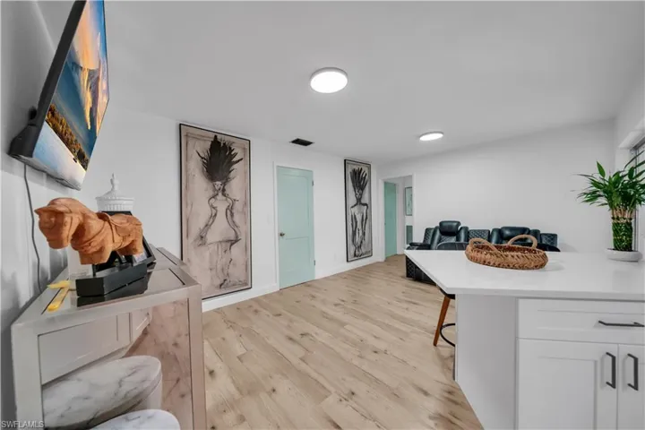 Home office with light wood-type flooring and baseboards