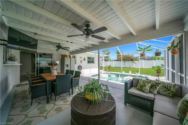 Fenced backyard featuring a patio, an outdoor hangout area, a ceiling fan, and outdoor dining space