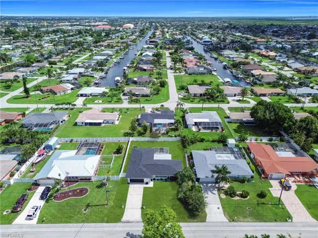 Aerial view of property's location featuring nearby suburban area
