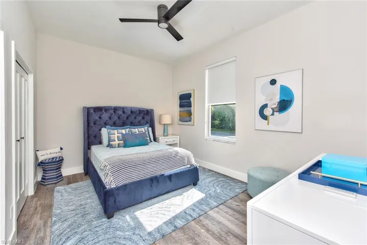 Bedroom featuring ceiling fan and hardwood / wood-style flooring