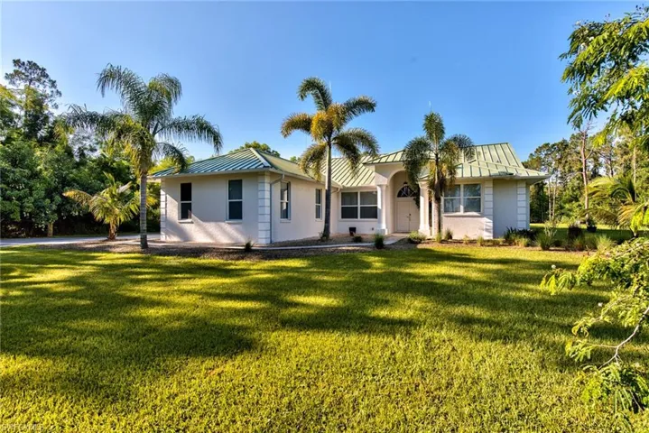 Rear view of property with a lawn