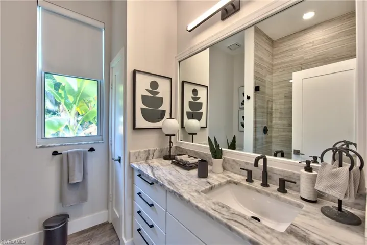Bathroom featuring hardwood / wood-style floors, a shower, and vanity