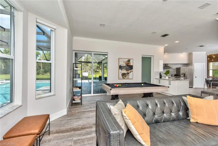 Game room featuring hardwood / wood-style flooring, crown molding, pool table, and a textured ceiling