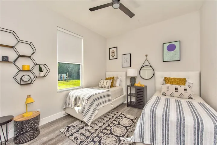 Bedroom featuring ceiling fan and wood-type flooring