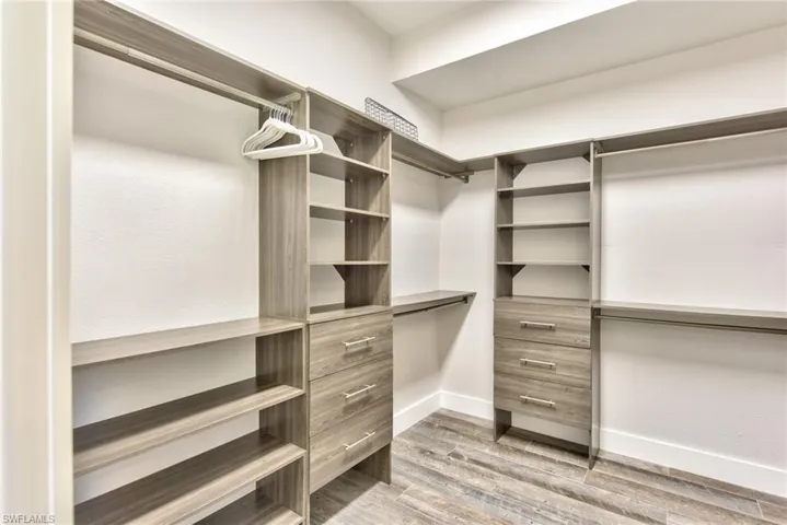 Spacious closet with light wood-type flooring