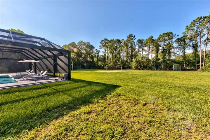 View of yard with glass enclosure