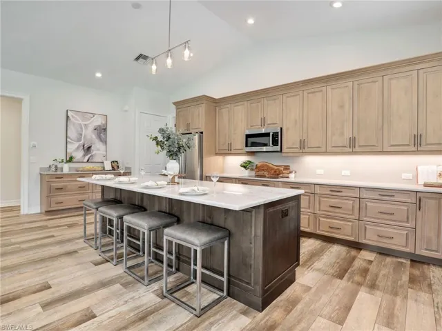 Oversized island w/ wood soft close cabinetry