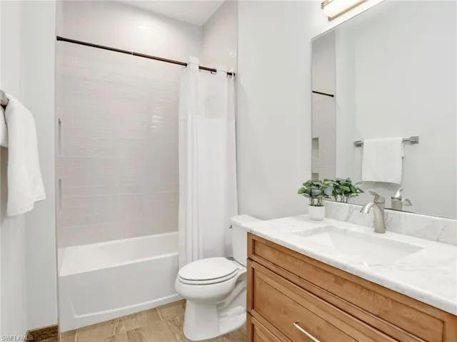 Full bath featuring shower / tub combo with curtain and vanity