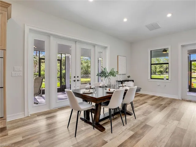 Dining room with recessed lighting, light wood-type flooring, and french doors
