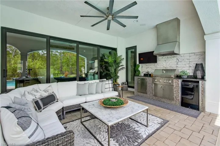 Living room featuring a textured ceiling and ceiling fan