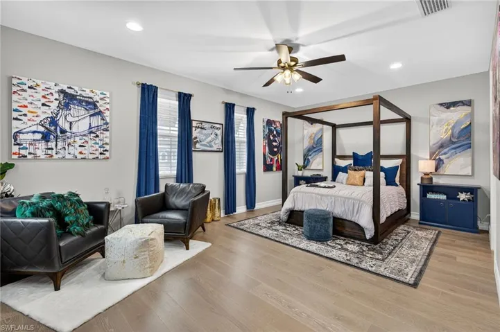 Bedroom featuring recessed lighting, wood finished floors, and a ceiling fan