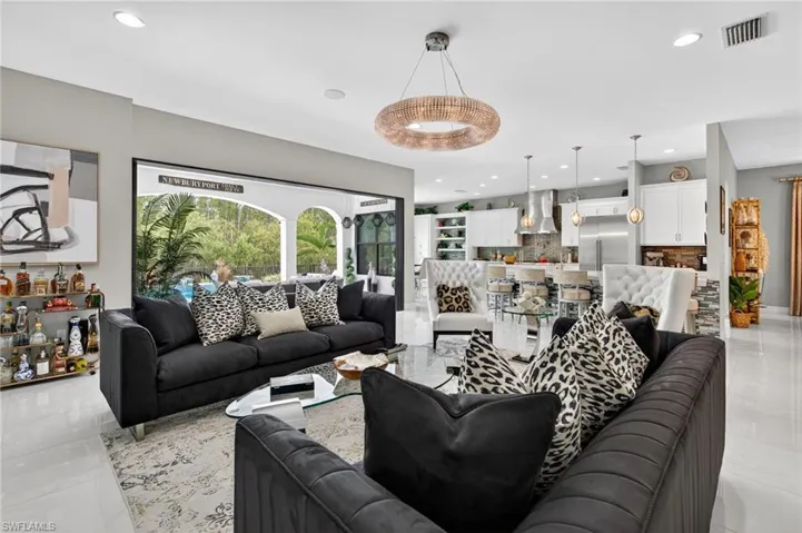 Living room with light tile patterned floors and recessed lighting