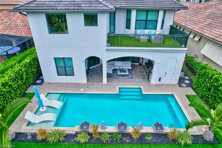 Rear view of house featuring an outdoor living space, a fenced in pool, and a patio