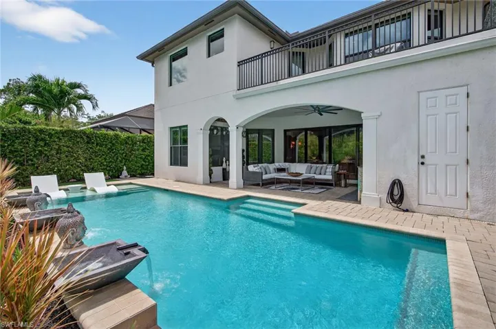 View of swimming pool with an outdoor hangout area, a patio area, a balcony, and ceiling fan