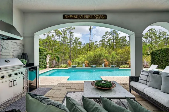 View of pool featuring an outdoor living space, a patio, and an outdoor kitchen