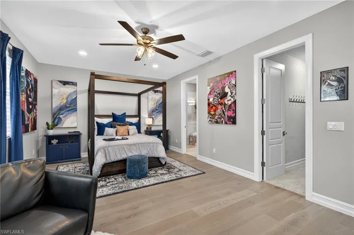 Bedroom with light wood-type flooring, recessed lighting, and a ceiling fan
