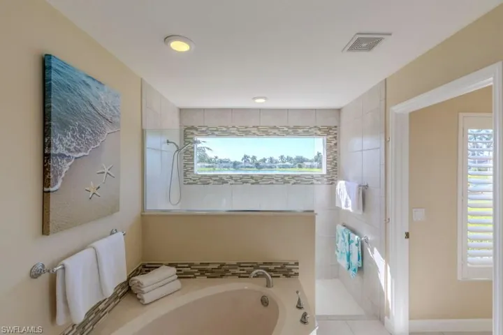 Bathroom featuring tile patterned floors and independent shower and bath