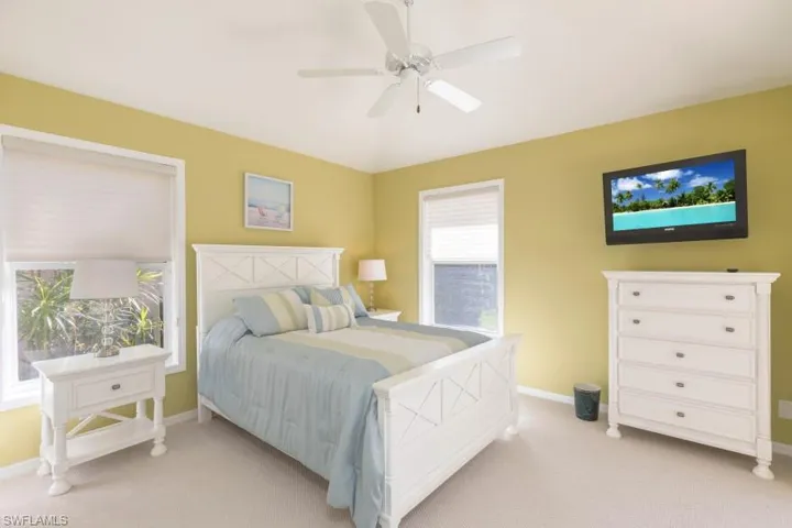 Carpeted bedroom with ceiling fan