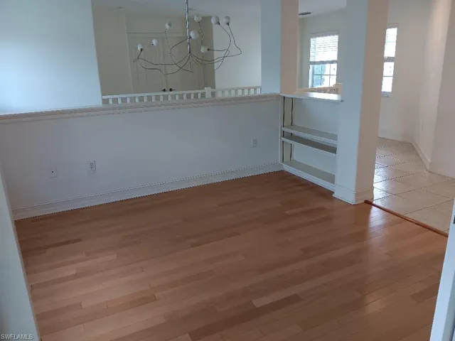 Spare room featuring light hardwood / wood-style flooring and a chandelier