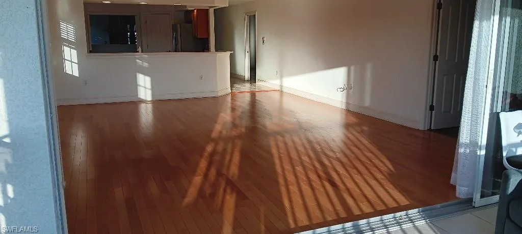Unfurnished living room featuring hardwood / wood-style flooring