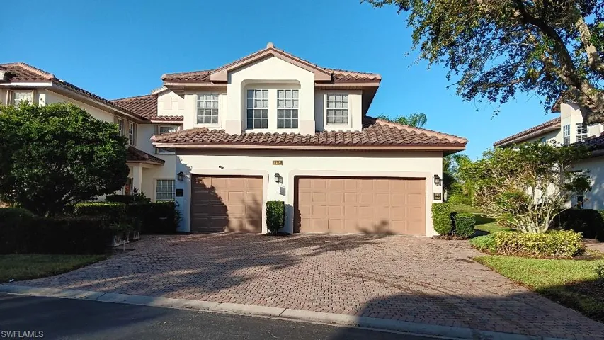 Mediterranean / spanish-style home with a garage