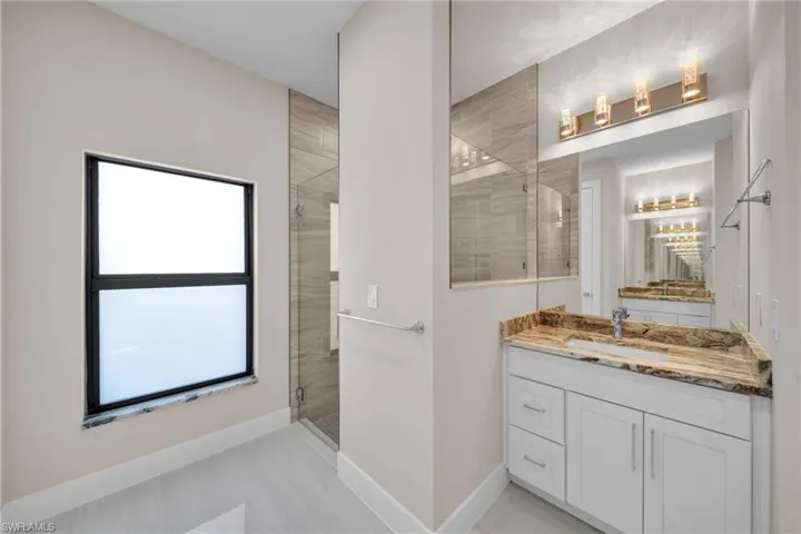 Full bathroom featuring vanity and a stall shower