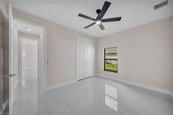 Unfurnished bedroom featuring ceiling fan and a closet