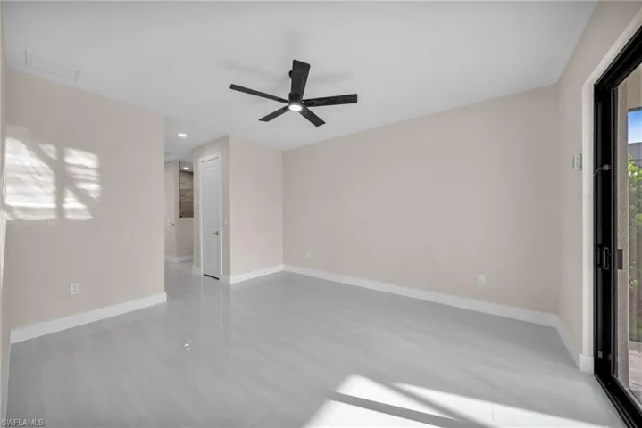 Unfurnished room with baseboards and ceiling fan