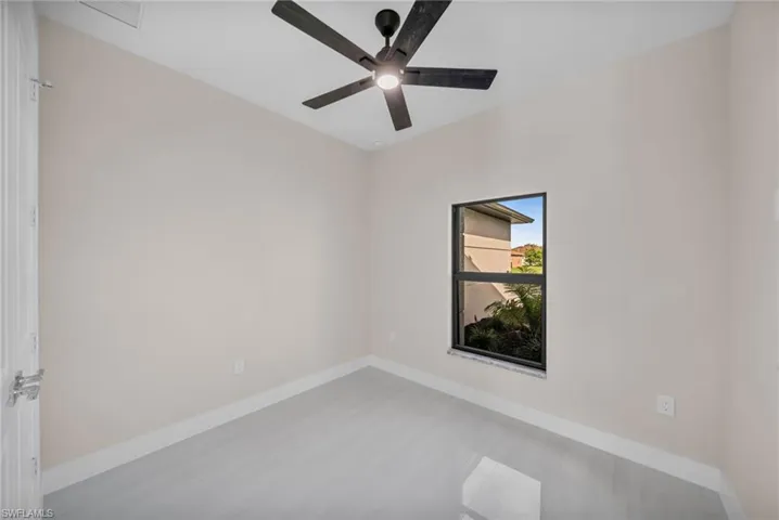 Unfurnished room with baseboards and a ceiling fan
