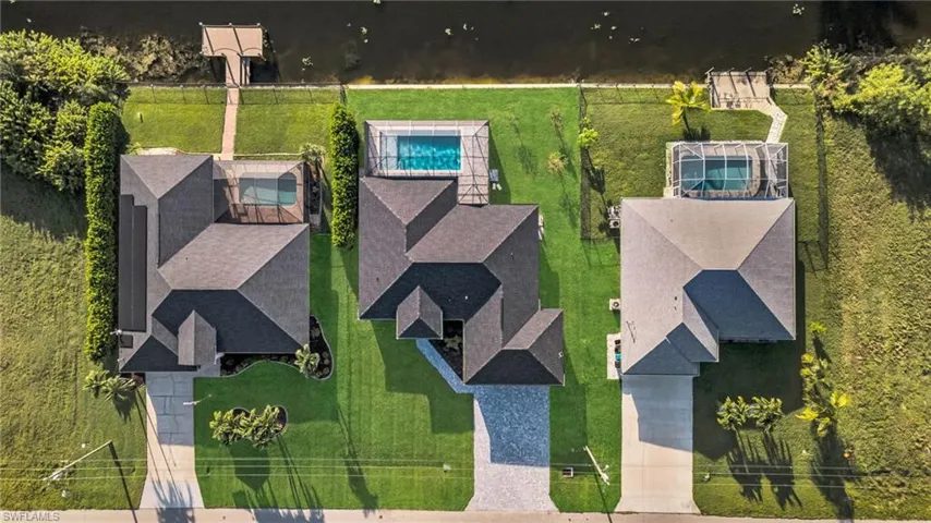 View of subject property with a pool area