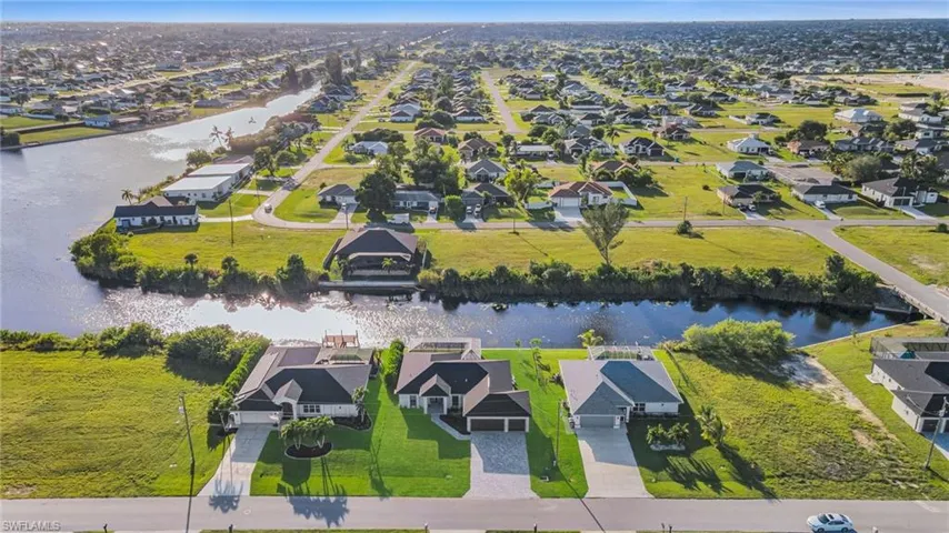 Aerial view of residential area featuring a large body of water