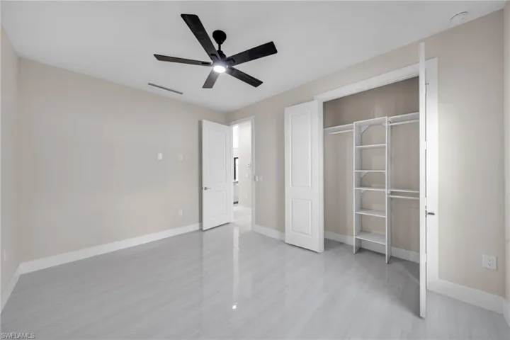 Unfurnished bedroom with a closet and ceiling fan