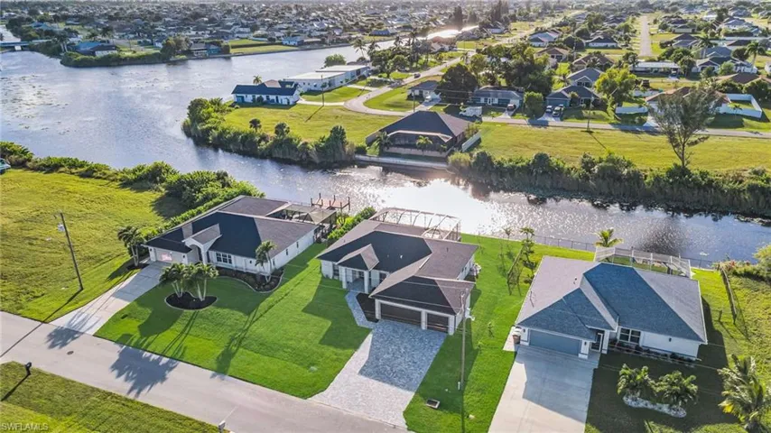 Aerial view of residential area featuring a nearby body of water