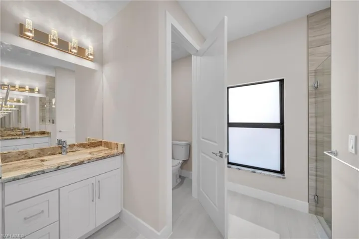 Bathroom with vanity and a stall shower