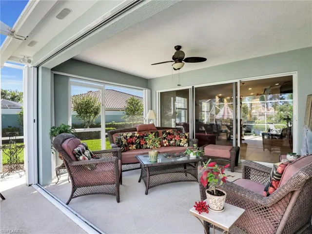 Sunroom / solarium with a wealth of natural light and ceiling fan