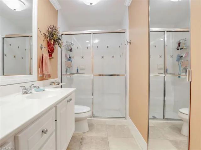 Bathroom featuring tile flooring, vanity, and toilet