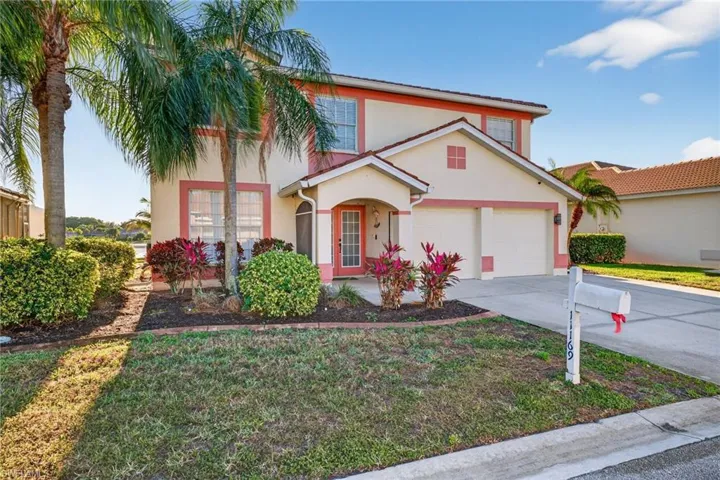 Aerial view of residential area featuring a nearby body of water