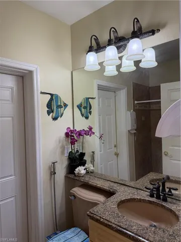 Living area featuring crown molding, light tile patterned flooring, and ceiling fan