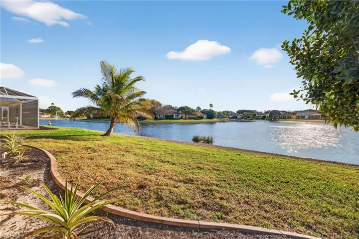Dining space with suspended lighting, light colored carpet, and ornamental molding