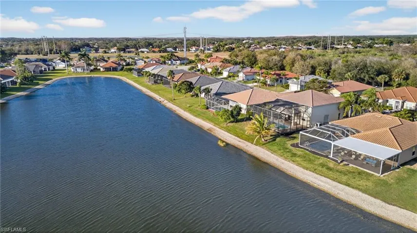 Aerial view of residential area featuring a nearby body of water