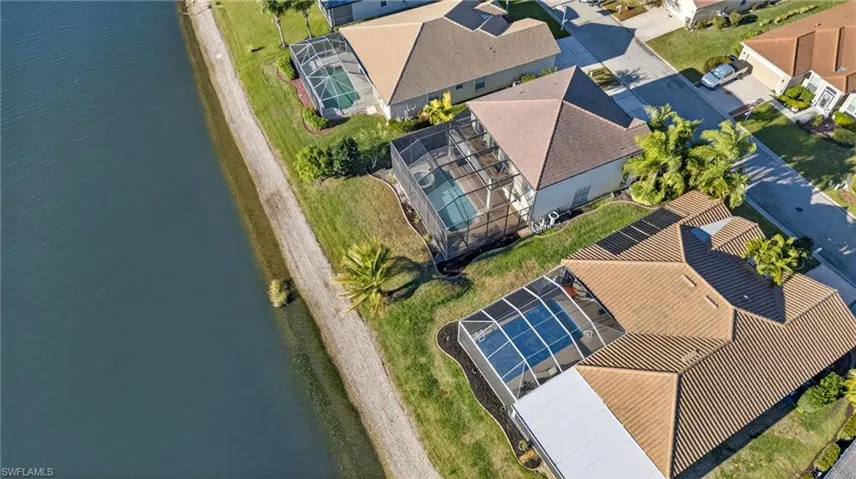 Aerial perspective of suburban area featuring a large body of water