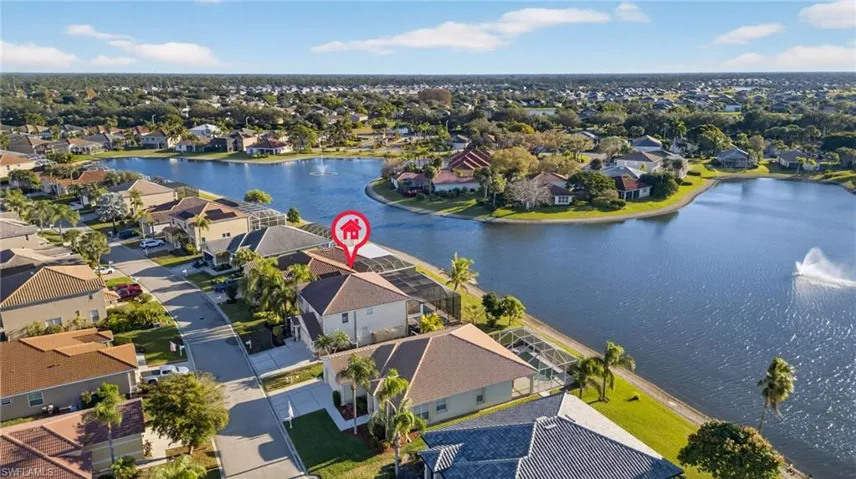 Aerial perspective of suburban area featuring a nearby body of water