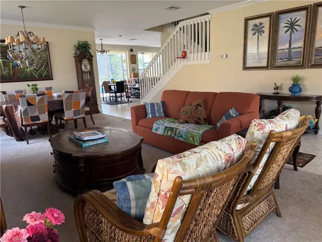 View of swimming pool featuring glass enclosure, a sunroom, a pool with connected hot tub, and a water view