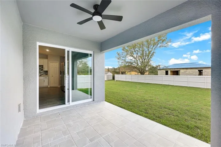 View of patio featuring ceiling fan and fence