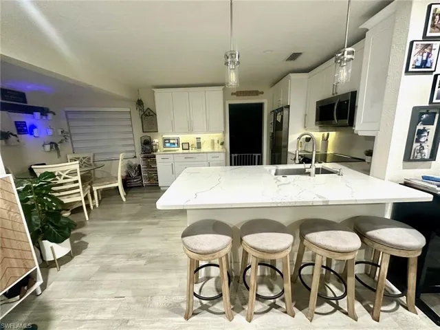beautiful updated kitchen with quartz counters and soft pull drawers