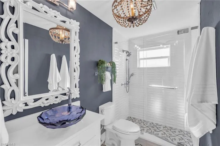 Full bath featuring a shower stall and vanity