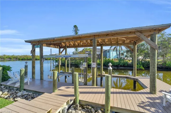 Dock area with boat lift and a water view